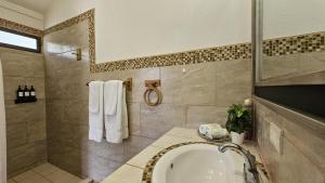 a bathroom with a sink and a shower and a tub at Casa Macaw Jungle Cabin w Private pool Wifi and AC in Quepos +29 photos