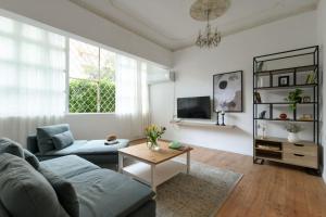 a living room with a couch and a table at Homey & Spacious 2BR Apt in the Heart of Tel-Aviv by Sea N' Rent in Tel Aviv