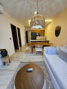 a living room with a couch and a table at Luxe Tulum Jacuzzi in Tulum