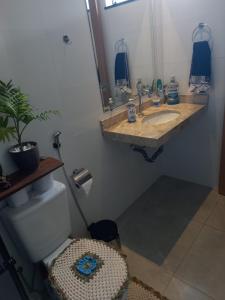 a bathroom with a sink and a mirror and a toilet at Casa Ampla COP30 in Belém +24 photos