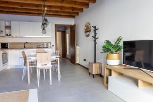 a kitchen and dining room with a table and chairs at Ca' Linda By Case al Lago in Desenzano del Garda