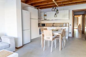a kitchen and dining room with a table and chairs at Ca Linda By Case al Lago in Desenzano del Garda +23 photos