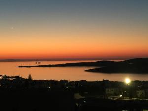 a sunset over a large body of water at Sunset View Hotel in Parikia