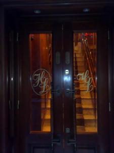 two glass doors of a building with a staircase at Hotel Lux in Venice