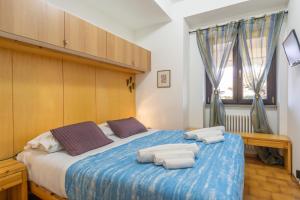 Postel nebo postele na pokoji v ubytování Il Giardino di Via Parrocchiale