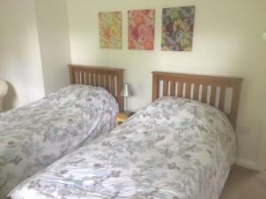 two beds sitting next to each other in a bedroom at Ballacowell in Sulby