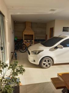 a white car parked in a garage with a fireplace at Casa Ampla COP30 in Belém