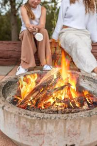 two people sitting around a fire in a fountain at Ocean views Close to Coolum Pet friendly Firepit Mountain Views in Yandina Creek +81 photos
