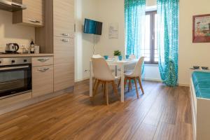 a kitchen and dining room with a table and chairs at Carpione By Case al Lago in Desenzano del Garda