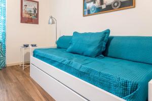 a blue couch in a room with a table at Carpione By Case al Lago in Desenzano del Garda