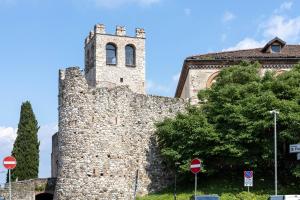 a large stone building with a tower on top of it at Carpione By Case al Lago in Desenzano del Garda