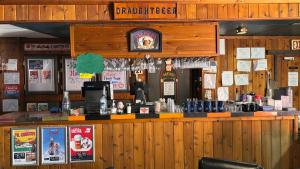a bar in a restaurant with signs on the wall at Wakaw Inn in Wakaw