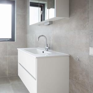 a white bathroom with a sink and a mirror at Lake-nature Villa 3 Bedrooms, Sleeps 7 in Ewijk +58 photos