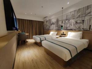 Postel nebo postele na pokoji v ubytování City Comfort Inn Ji'an County Junshan Avenue