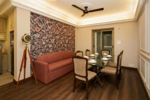 a living room with a couch and a table at City Haven by JadeCaps2BHKAlipore in Kolkata +12 photos