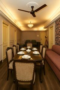 a dining room with a table and a couch at City Haven by JadeCaps2BHKAlipore in Kolkata