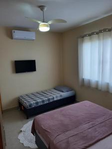 a bedroom with two beds and a ceiling fan at Casa Ampla COP30 in Belém