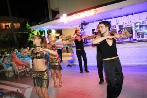 a group of people dancing on a dance floor at Blue Palace Apart Hotel in Marmaris