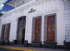 a white building with red doors on a street at PAQARIY Hs in Arequipa