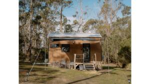 a small shack in the middle of a forest at Banyula Cove by Tiny Away in Barnes Bay