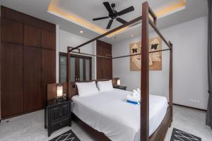a bedroom with a bed and a ceiling fan at VILLA ATA | Private Pool | Saiyuan Estate by Tropiclook | Nai harn beach in Nai Harn Beach +36 photos