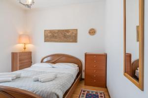 a bedroom with a bed and a dresser and a mirror at Rifugio nel verde in Cremeno