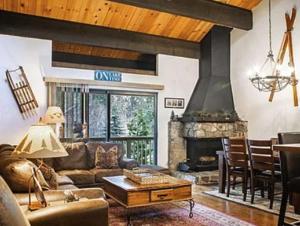 a living room with a couch and a fireplace at Streamside Townhome in Kings Beach