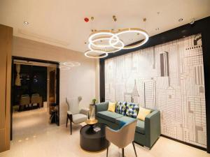 a living room with a couch and chairs and a chandelier at City Comfort Inn Changsha Sifangping University of National Defense Science and Technology in Changsha