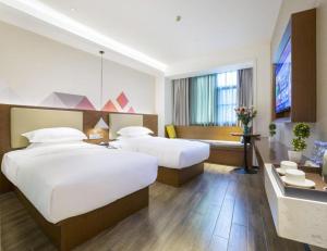Postel nebo postele na pokoji v ubytování Borrman Hotel Guangzhou Southern Hospital Meihuayuan Metro Station + 201 fotografií