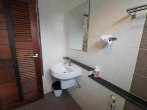 un bagno con lavandino e specchio di RoomQuest Chiang Mai Tha Sala a Chiang Mai