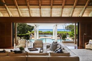 a living room with a couch and a view of the ocean at Mauna Lani, Auberge Collection in Puako