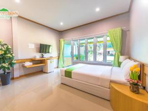 Ένα ή περισσότερα κρεβάτια σε δωμάτιο στο Phutara Resort +181 φωτογραφίες