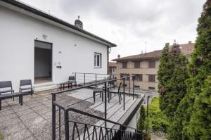 a balcony with benches and a white building at Miro' dreams in Alzate Brianza
