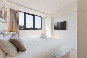 Ένα ή περισσότερα κρεβάτια σε δωμάτιο στο Breeze Mooloolaba (APT 503)
