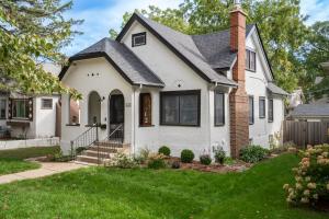 a white house with a black roof at Fulton Gates in Minneapolis