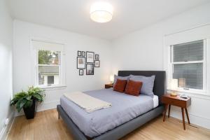 a bedroom with a bed and two windows at Fulton Gates in Minneapolis