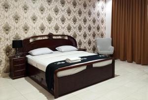 a bedroom with a bed and a chair in a room at The Garden Hotel in Gorontalo +50 photos