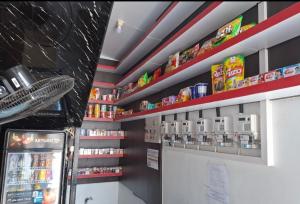 a store aisle with shelves of food and drinks at Hotel Sudut Tidur in Stasiun Tawang