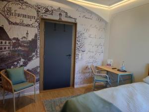 a bedroom with a wall with writing on the wall at Schloss Kalteneck in Schwenningen
