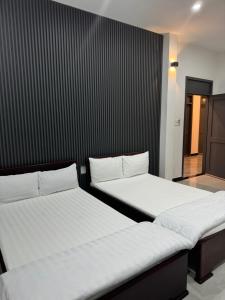 Postel nebo postele na pokoji v ubytování Khách sạn CÁT TƯỜNG