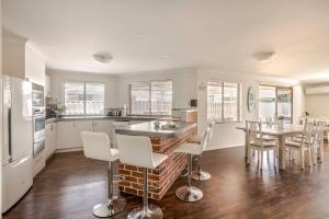 a kitchen and dining room with a table and chairs at Spindrift Escape in Dunsborough
