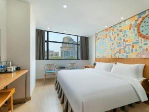 Ένα ή περισσότερα κρεβάτια σε δωμάτιο στο Insail Hotels Dongshankou Subway Station Guangzhou +208 φωτογραφίες