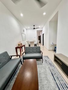 a living room with a couch and a table at Casa Damai Kuantan - near Taman Tas, SEMSAS, UMP,Airport, Uia, Matrik Gambang, Menara 188, 4bilik-3AC 1kipas, Ruang Tamu kipas in Kuantan