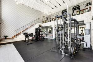 a gym with treadmills and machines in a room at Smart Apartment Luxury in Midrand