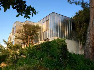 a house with glass panels on the side of it at Silver Box Beverly Hills in Los Angeles
