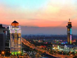 a view of a city at night with a building at Zhangjiagang Zhonglian GDH International Hotel in Zhangjiagang