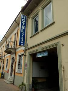 a building with a blue sign on the side of it at Hotel Niagara in Caselle Torinese