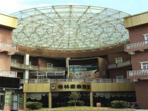 a large building with a glass dome on top of it at GreenTree Inn Kunshan Shimao Plaza Business Hotel in Suzhou