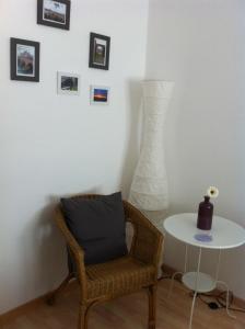 a room with a chair and a table and a vase at Ferienwohnung J.Weber in Hornbach