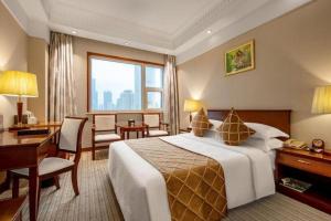 a hotel room with a large bed and a desk and a desk at Shaanxi Business Hotel in Shanghai +180 photos